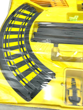 Load image into Gallery viewer, Detail view of Tyco train track pieces showing curved track and plastic material.
