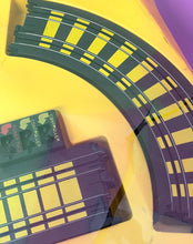 Load image into Gallery viewer, Tyco Daredevil Super Cliff Turbovettes Set close-up of black plastic pieces with curved shape and grid pattern.

