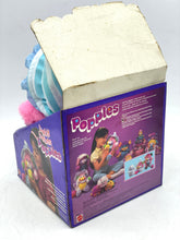 Load image into Gallery viewer, Back view of colorful plush toy with illustrated packaging.
