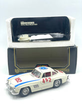 Load image into Gallery viewer, Burago Mercedes 300SL lifestyle shot with displayed car and open packaging.
