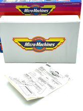Load image into Gallery viewer, Galoob Micro Machines Truck 'N Service Centre interior detail showing instruction manual and product information.
