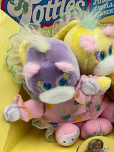 Carica l'immagine nel visualizzatore di Gallery, Side view of Mattel Turtle Tots plush toys in display box.

