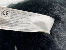 Load image into Gallery viewer, Detail of care label on Dan Dee Black Ape Gorilla plush with safety information.
